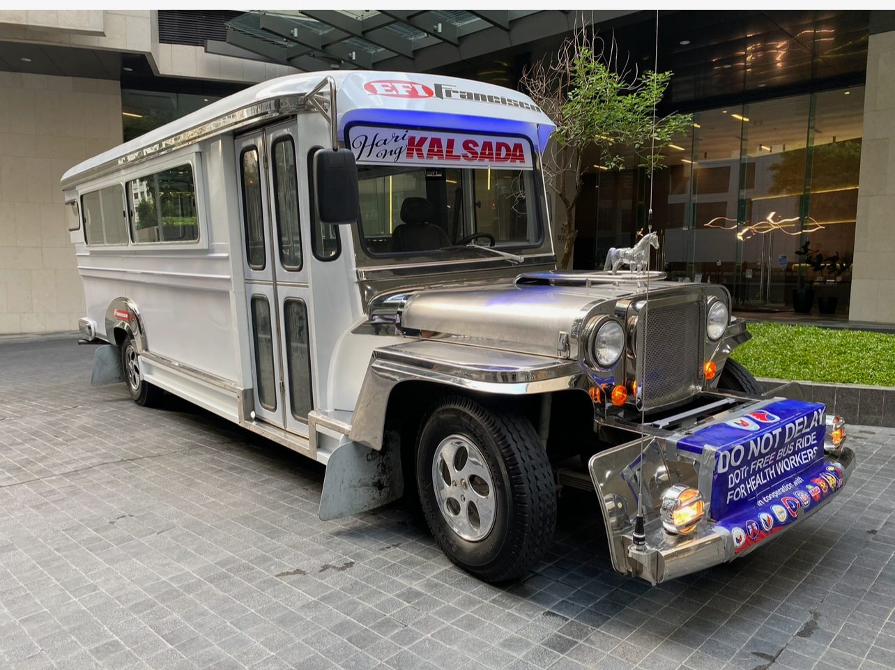 The built Francisco Jeepney, King of the Road, at a building entrance